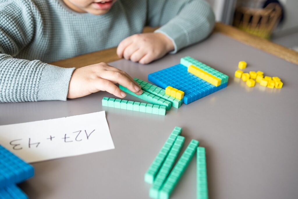 child working with math cubes